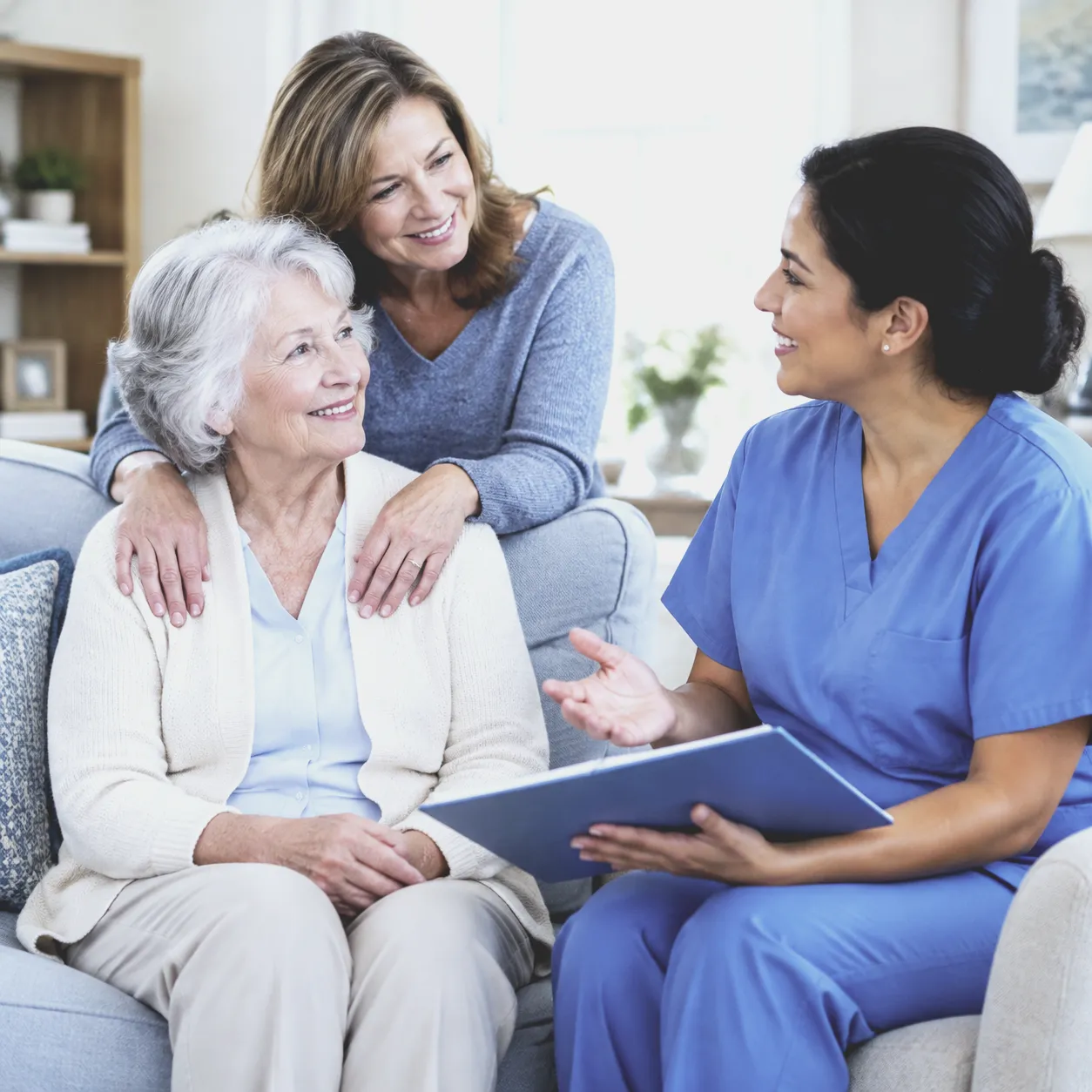 A nurse talks a care plan through with an older woman and her daughter at home